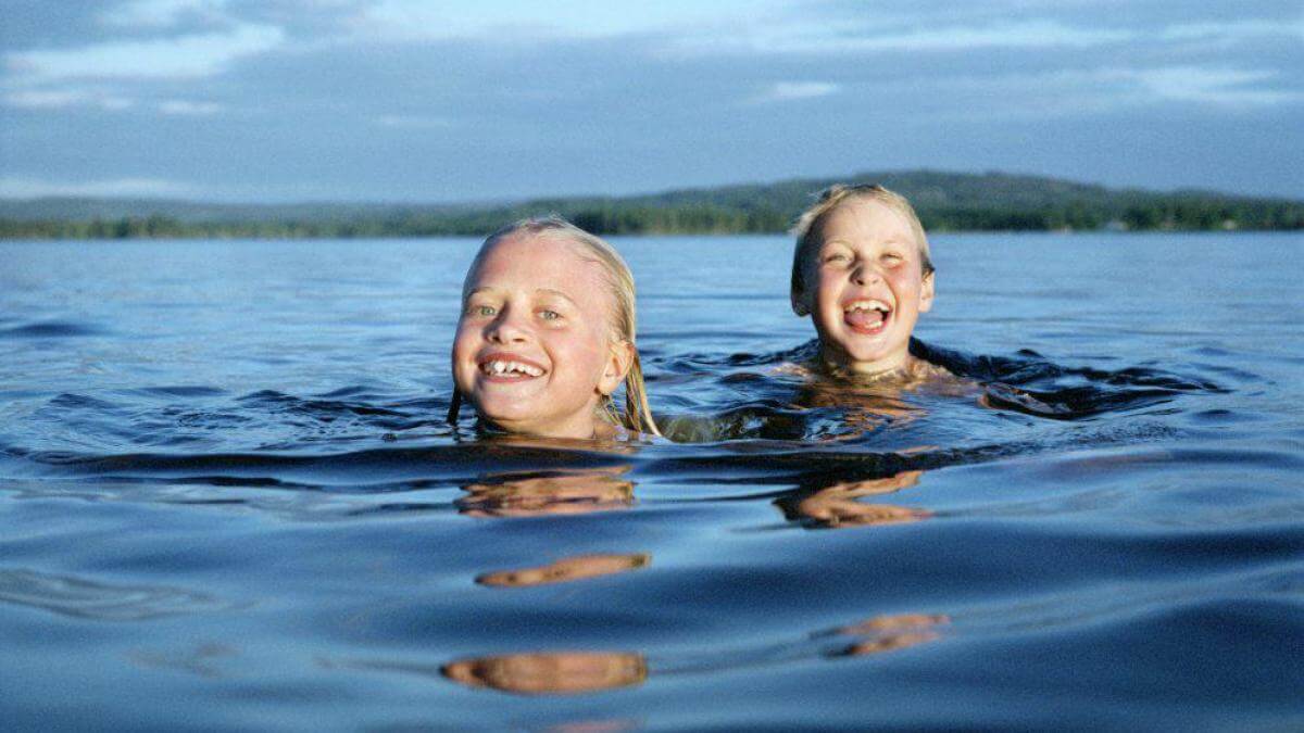 Boy and girl swimming in lake.jpg - Travel and Golf Influencer - AmerExperience Content Curator