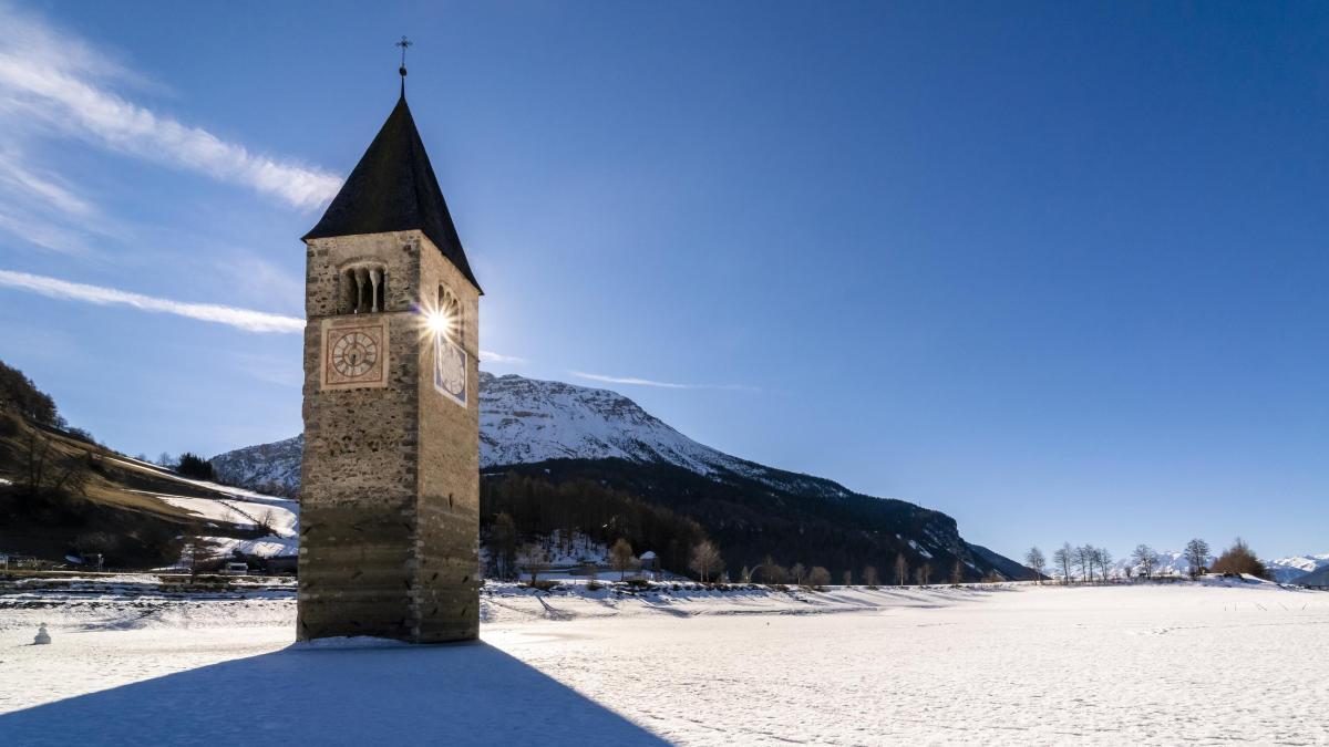 Italy Venosta Valley Sunken spire in frozen Lago di Resia in winter.jpg