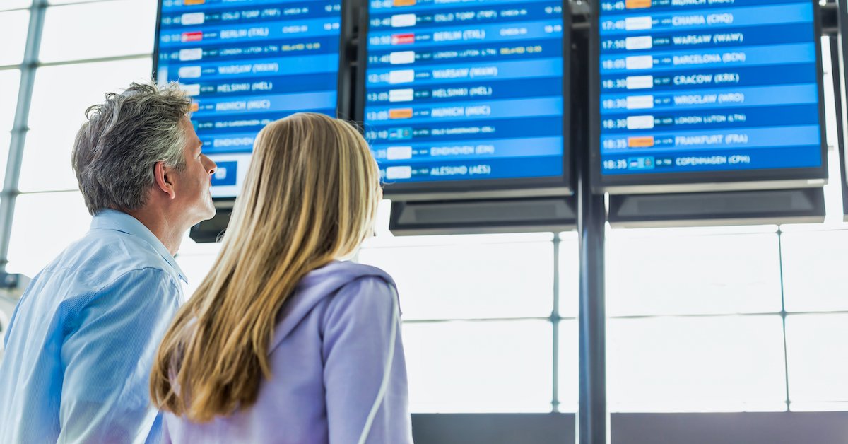 family checking flight board fb.jpg