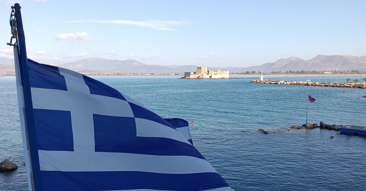 greek flag over water.jpg