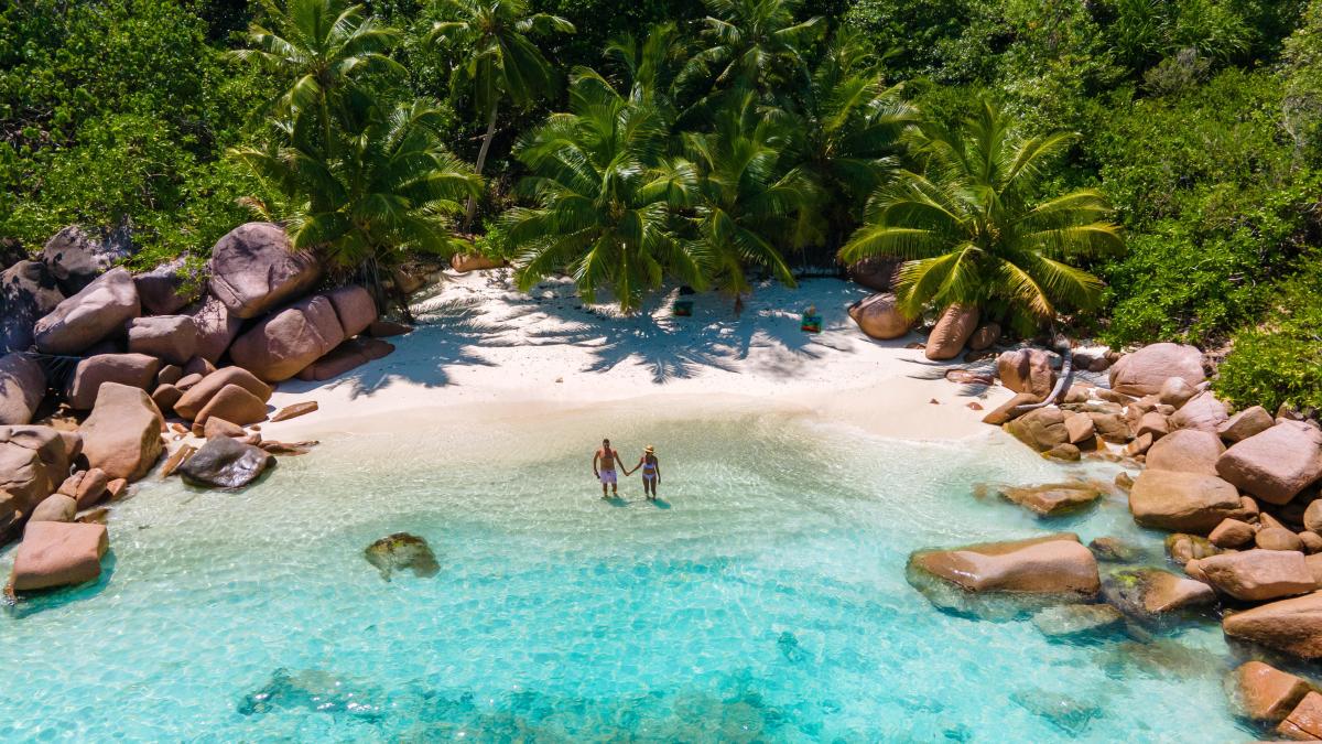 Anse Lazio Praslin Seychelles young couple men and woman on a tr.jpg - Travel and Golf Influencer - AmerExperience Content Curator