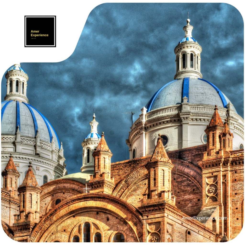 Blue-and-white domes and ornate brickwork of Cuenca’s New Cathedral beneath dark clouds.