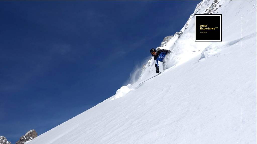 Skiing: Skier descending a snow-covered mountain in the Austrian Alps