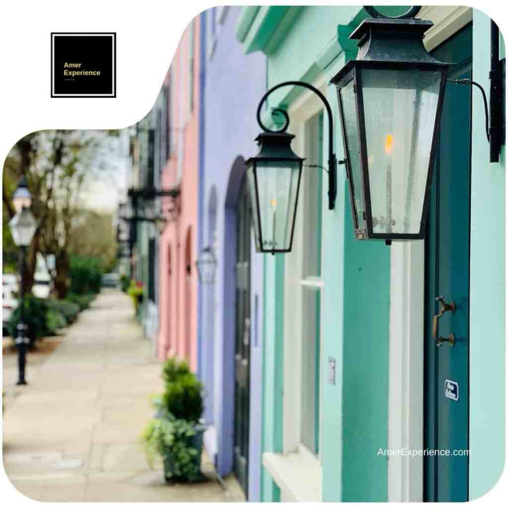 Historic Charleston architecture featuring iconic pastel-colored buildings and traditional wrought-iron gas lanterns, a signature view curated by AmerExperience by Lassi Pensikkala.