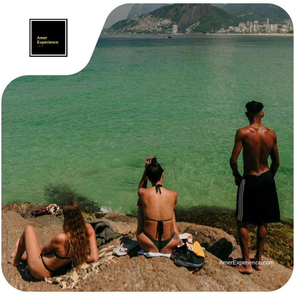 Travelers relaxing beside green Atlantic waters near Rio de Janeiro