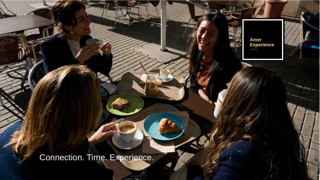 Travelers enjoying coffee together at a local café during a relaxed slow travel experience.