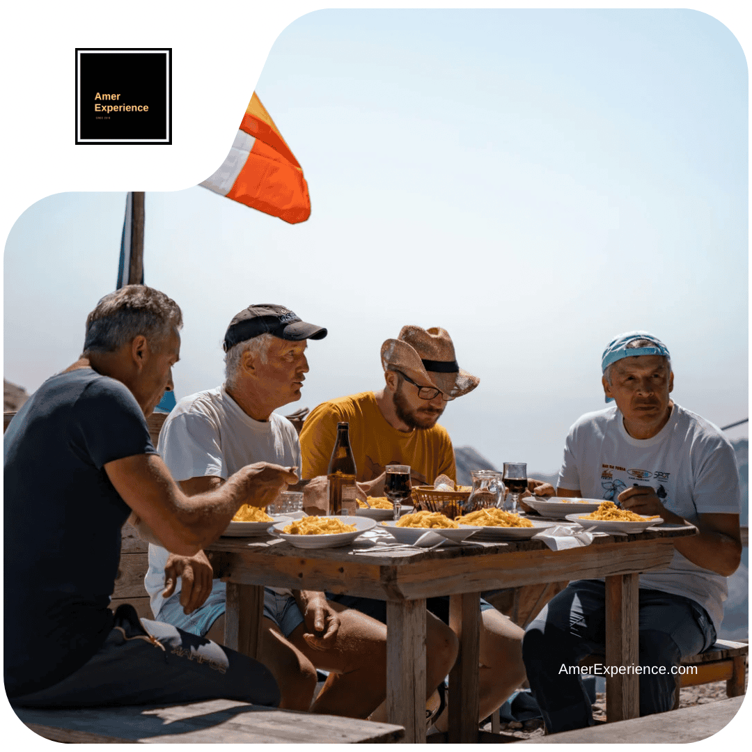 Four men enjoying a meal outdoors.